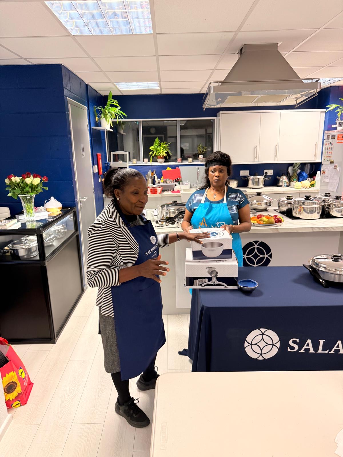 Verna demonstrating Saladmaster cookware in her kitchen showroom
